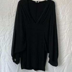 Black tunic top with sheer sleeves.